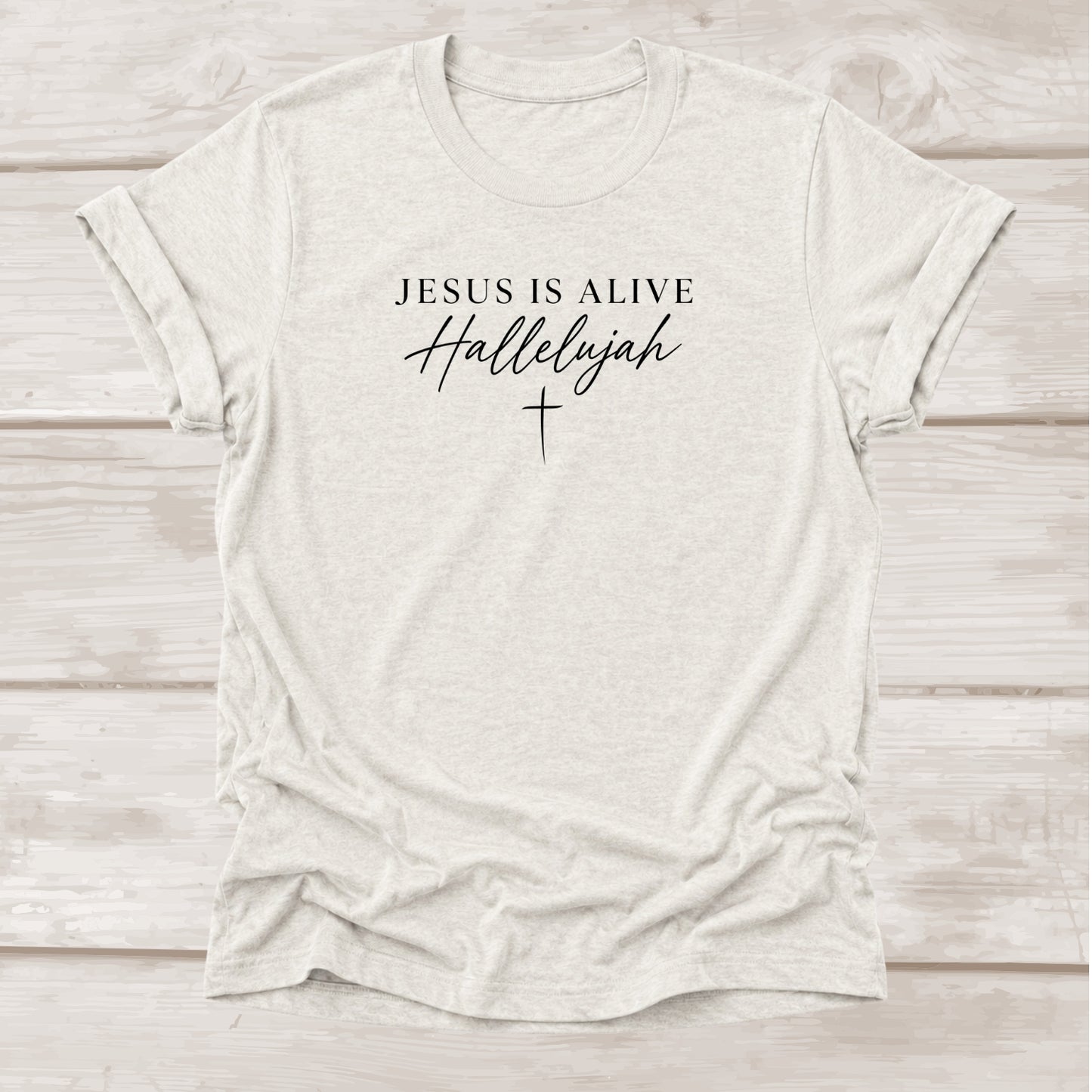 Jesus Is Alive Hallelujah Christian t-shirt with cross graphic in heather cement β BEE Grace-full